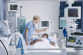 Nurse tending patient in intensive care